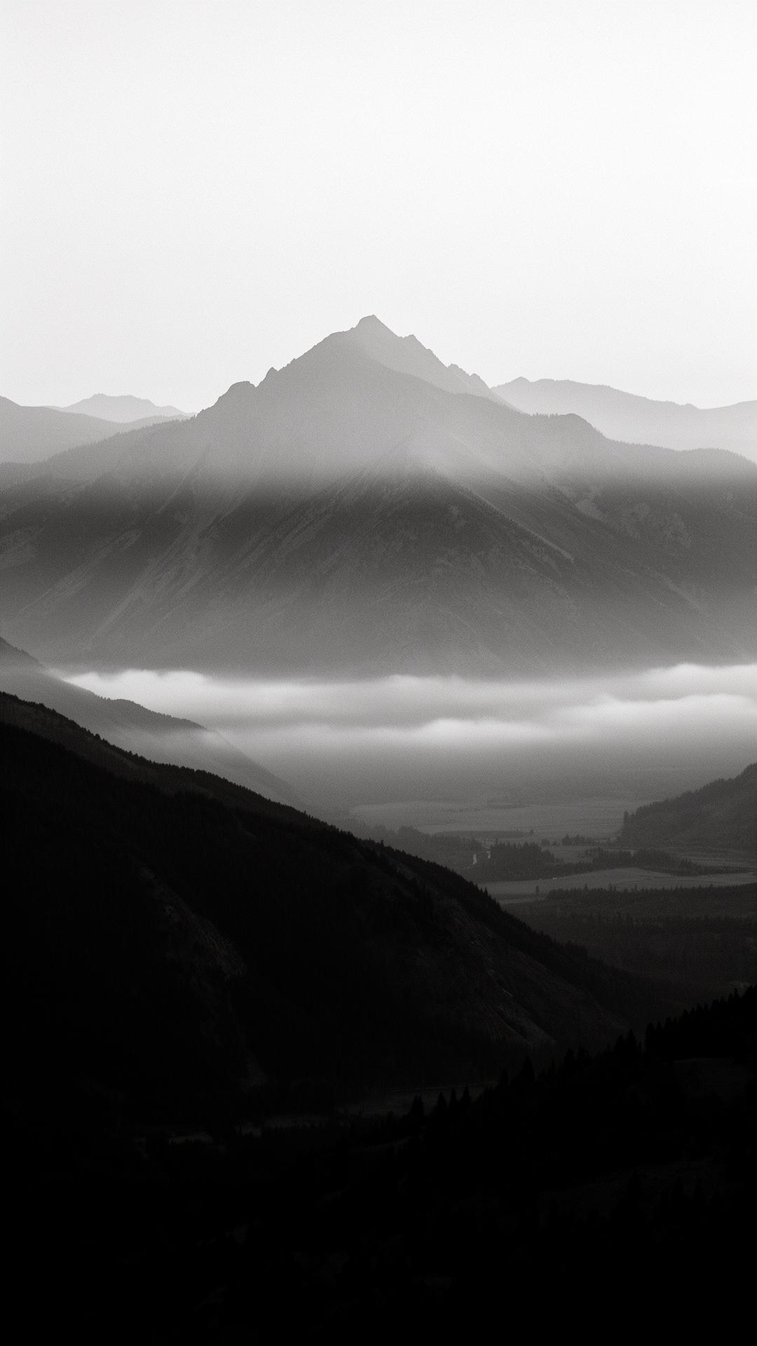 A solitary mountain peak rising above a sea of mist, the long view
